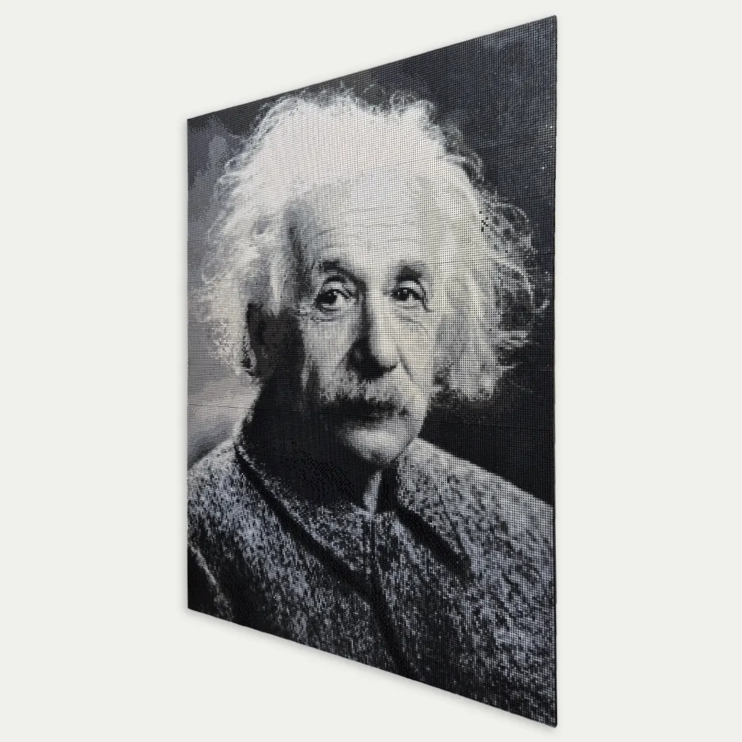 A black and white portrait made of round tiles, hanging on a wall